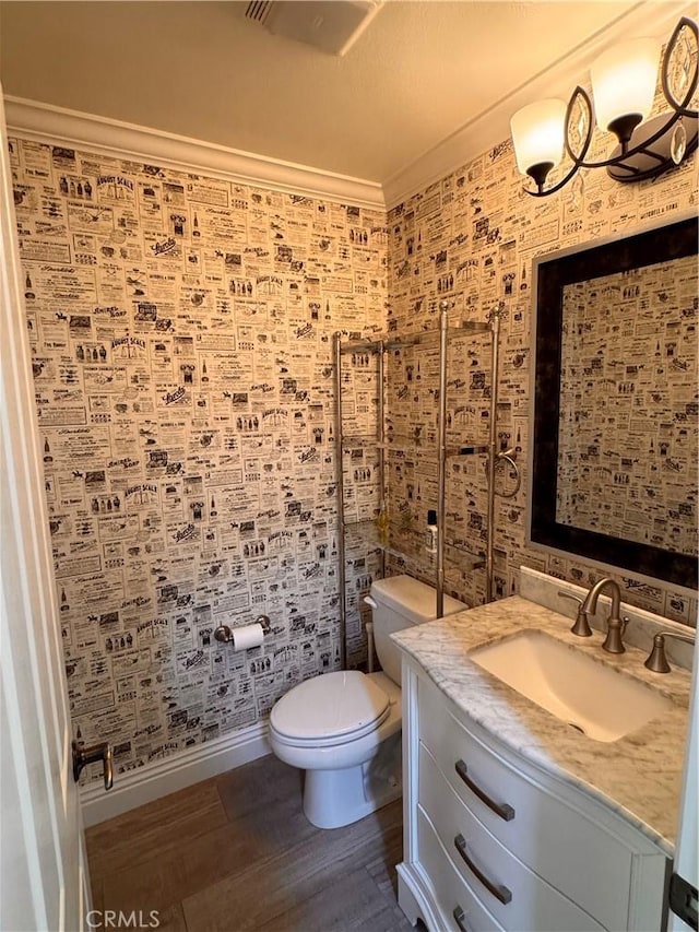 44 Arcata, Irvine, CA 92602 - bathroom featuring vanity, wood finished floors, wallpapered walls, and crown molding
