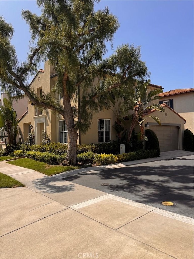 44 Arcata, Irvine, CA 92602 - mediterranean / spanish-style house featuring stucco siding and driveway