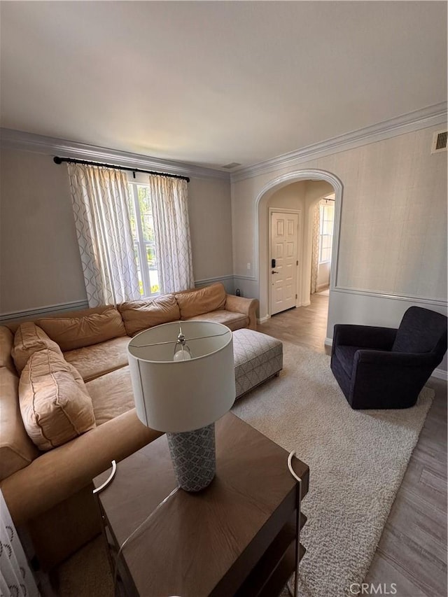 44 Arcata, Irvine, CA 92602 - living area with arched walkways, crown molding, and light wood-style flooring