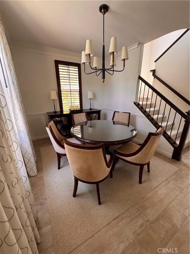 44 Arcata, Irvine, CA 92602 - dining area featuring a chandelier, ornamental molding, wood finished floors, and stairway