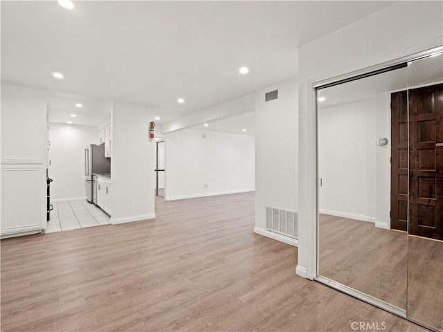 5334 Lindley Ave Unit 125, Encino, CA 91316 - unfurnished living room featuring light wood-type flooring and recessed lighting