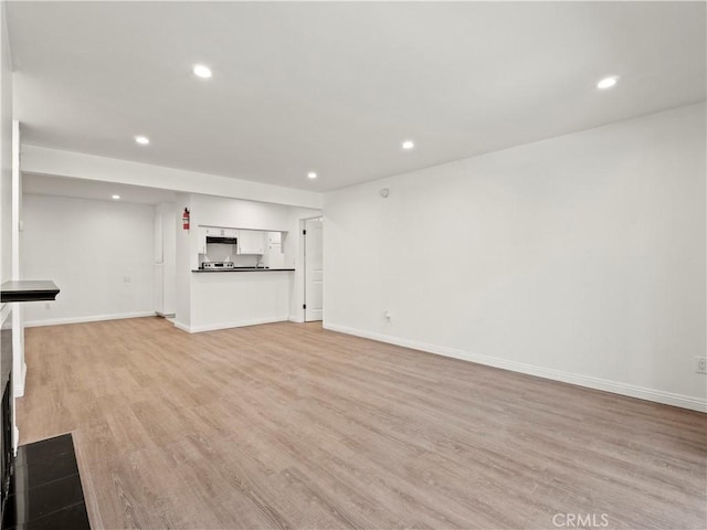 5334 Lindley Ave Unit 125, Encino, CA 91316 - unfurnished living room featuring light wood-type flooring and recessed lighting
