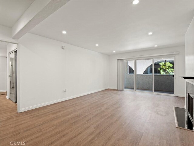 5334 Lindley Ave Unit 125, Encino, CA 91316 - unfurnished living room featuring a fireplace, light wood-type flooring, and recessed lighting