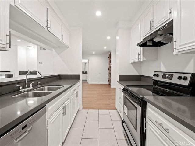 5334 Lindley Ave Unit 125, Encino, CA 91316 - kitchen with stainless steel appliances, under cabinet range hood, dark countertops, white cabinets, and recessed lighting