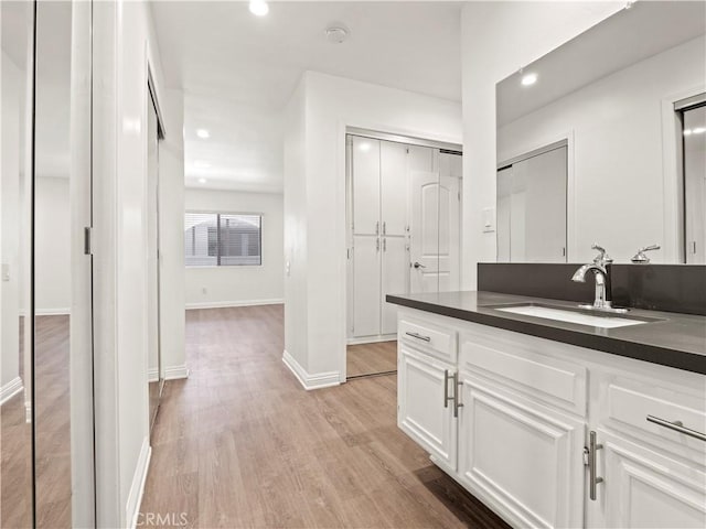 5334 Lindley Ave Unit 125, Encino, CA 91316 - bathroom featuring wood finished floors, vanity, and recessed lighting