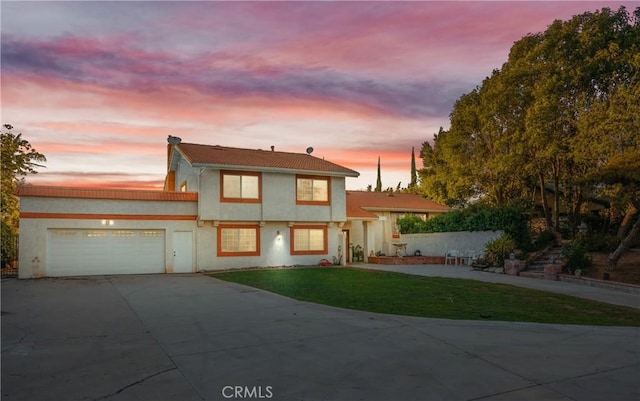 5266 Bluff St, Norco, CA 92860 - view of front facade featuring a garage, concrete driveway, a front lawn, and stucco siding