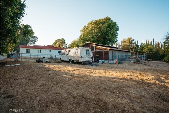5266 Bluff St, Norco, CA 92860 - back of house featuring an outbuilding and an exterior structure