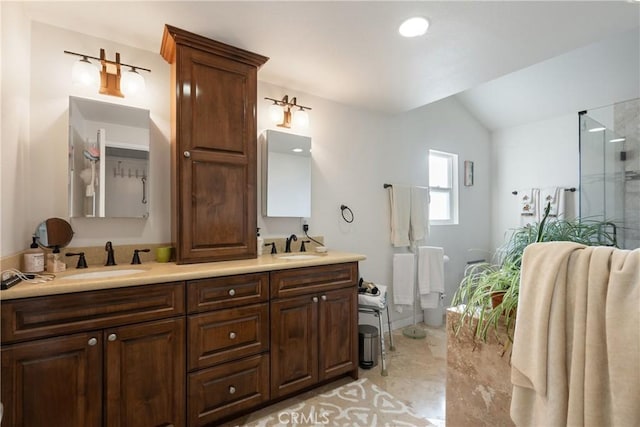5266 Bluff St, Norco, CA 92860 - full bathroom featuring double vanity, marble finish flooring, lofted ceiling, and a shower with door