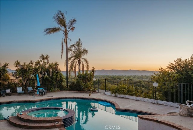 5266 Bluff St, Norco, CA 92860 - view of swimming pool featuring a pool with connected hot tub, a patio area, and a mountain view