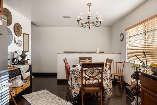 5266 Bluff St, Norco, CA 92860 - dining space with a chandelier and dark wood-style flooring