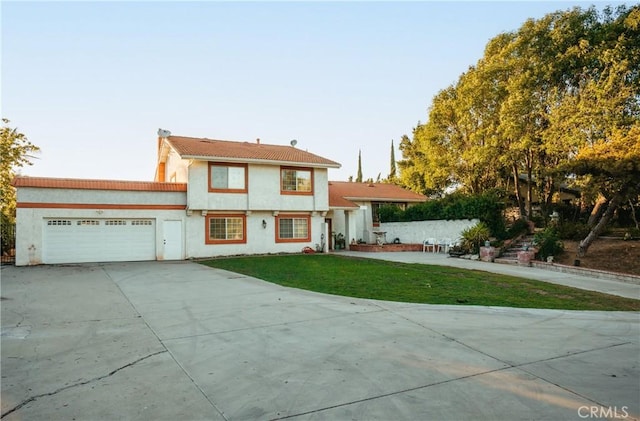5266 Bluff St, Norco, CA 92860 - view of front of home with an attached garage, driveway, a front yard, and stucco siding