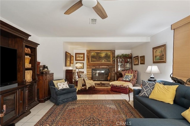 5266 Bluff St, Norco, CA 92860 - living area with light tile patterned flooring, a stone fireplace, and a ceiling fan