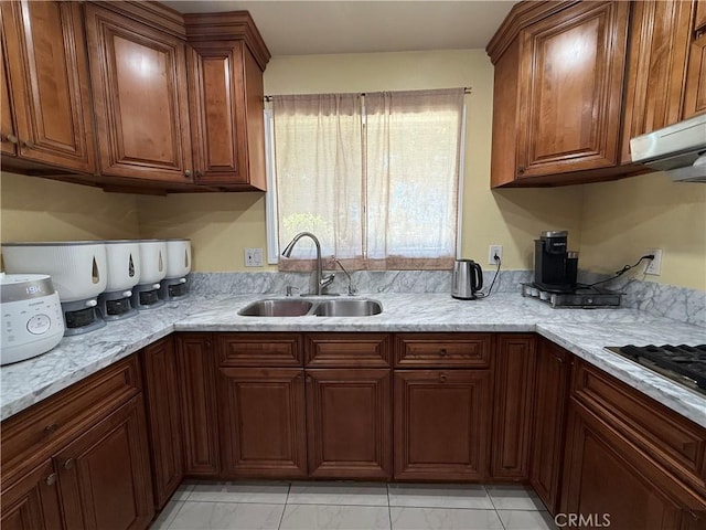 11057 Dudley Way, Stanton, CA 90680 - kitchen featuring light marble finish flooring, brown cabinets, light stone counters, stainless steel gas stovetop, and ventilation hood