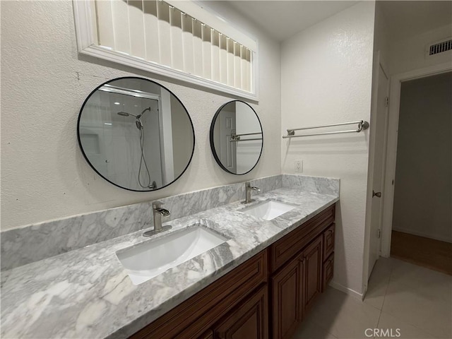11057 Dudley Way, Stanton, CA 90680 - bathroom featuring double vanity, tile patterned flooring, and a shower