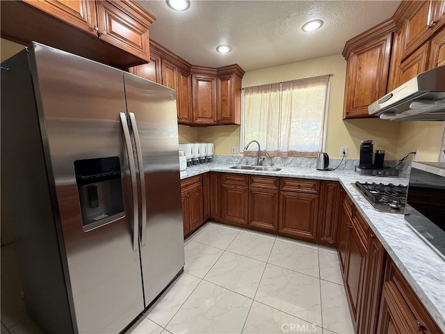 11057 Dudley Way, Stanton, CA 90680 - kitchen featuring stainless steel appliances, light marble finish floors, brown cabinetry, a textured ceiling, and exhaust hood