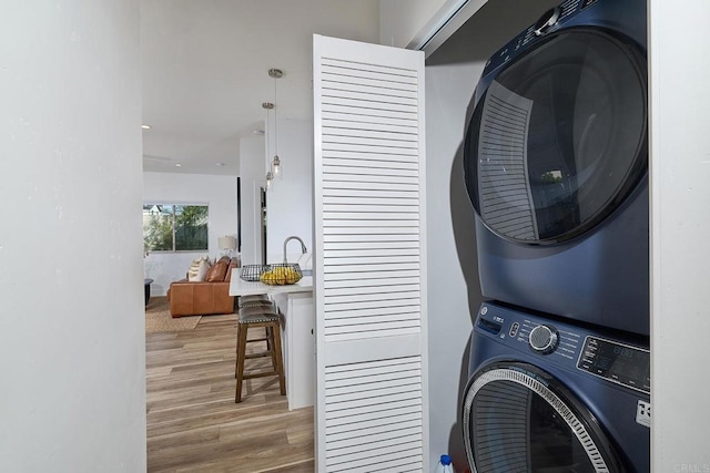 1506 Alvarado St, Oceanside, CA 92054 - washroom featuring stacked washing machine and dryer and wood finished floors