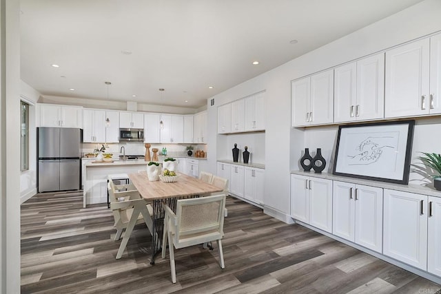 1506 Alvarado St, Oceanside, CA 92054 - kitchen with stainless steel appliances, dark wood-style flooring, white cabinets, light countertops, and recessed lighting