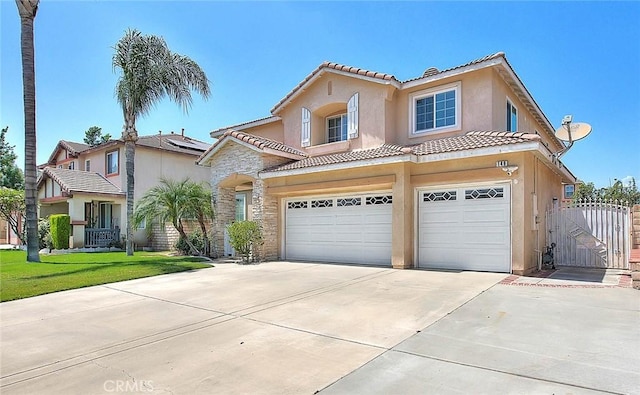149 E Saint Andrews St, Ontario, CA 91761 - view of front facade featuring an attached garage, a tile roof, concrete driveway, stucco siding, and a gate