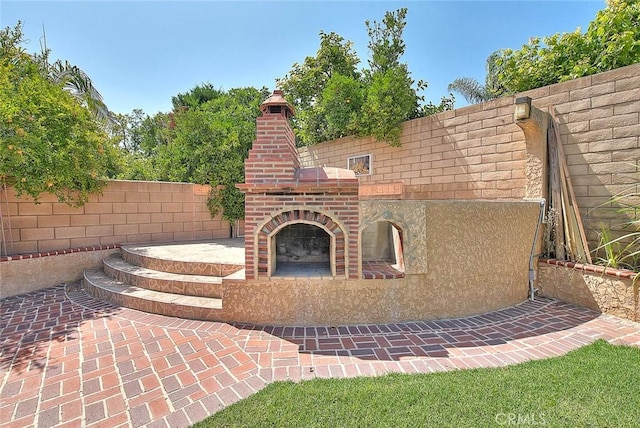 149 E Saint Andrews St, Ontario, CA 91761 - view of patio with an outdoor brick fireplace