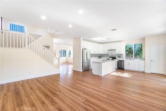 149 E Saint Andrews St, Ontario, CA 91761 - kitchen with stainless steel appliances, open floor plan, light countertops, plenty of natural light, and recessed lighting