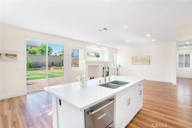 149 E Saint Andrews St, Ontario, CA 91761 - kitchen with stainless steel dishwasher, plenty of natural light, light wood-type flooring, light countertops, and recessed lighting