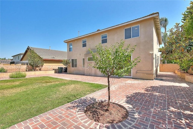149 E Saint Andrews St, Ontario, CA 91761 - rear view of house featuring stucco siding and a patio