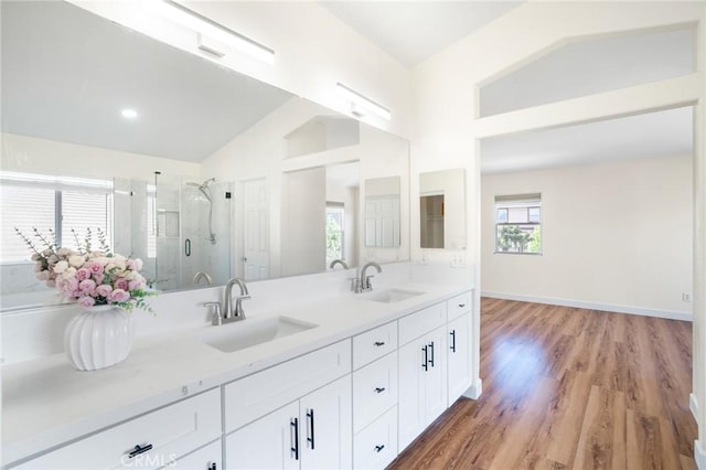 149 E Saint Andrews St, Ontario, CA 91761 - bathroom featuring double vanity, a stall shower, lofted ceiling, wood finished floors, and recessed lighting