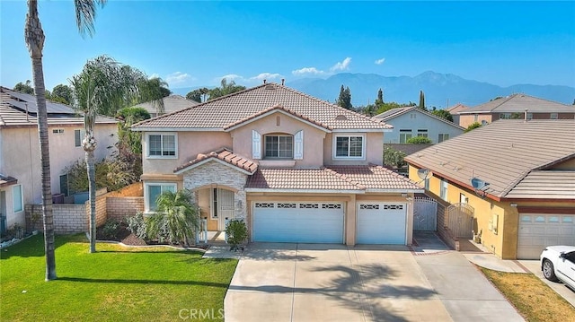 149 E Saint Andrews St, Ontario, CA 91761 - view of front facade with stucco siding, a tiled roof, a mountain view, concrete driveway, and stone siding