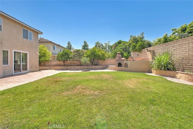 149 E Saint Andrews St, Ontario, CA 91761 - fenced backyard with a fireplace and a patio
