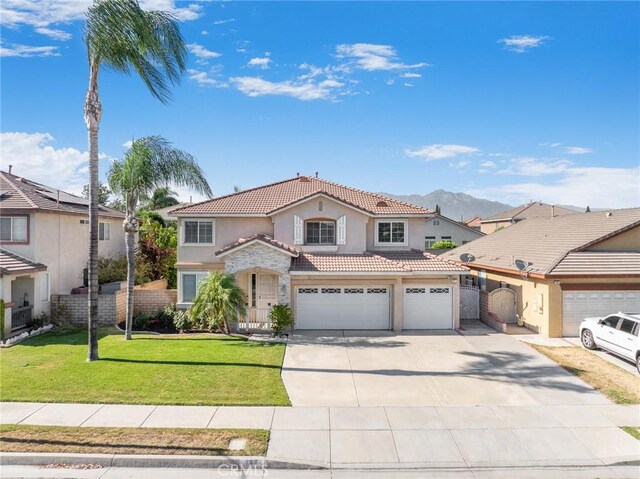 149 E Saint Andrews St, Ontario, CA 91761 - mediterranean / spanish-style house featuring stucco siding, a tiled roof, concrete driveway, stone siding, and an attached garage