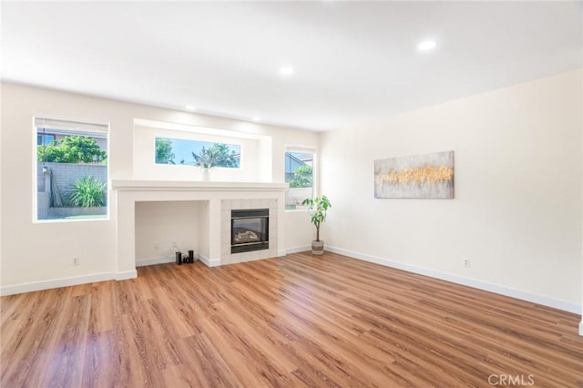 149 E Saint Andrews St, Ontario, CA 91761 - unfurnished living room featuring light wood-style floors, a fireplace, plenty of natural light, and recessed lighting