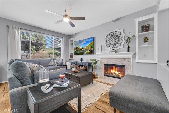 31164 Twilight Vista Dr, Menifee, CA 92584 - living area featuring a stone fireplace, wood finished floors, and ceiling fan