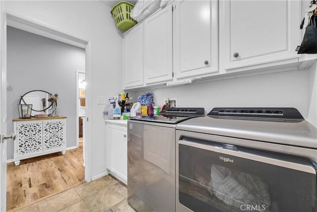 31164 Twilight Vista Dr, Menifee, CA 92584 - laundry room featuring washing machine and clothes dryer, cabinet space, and light tile patterned floors