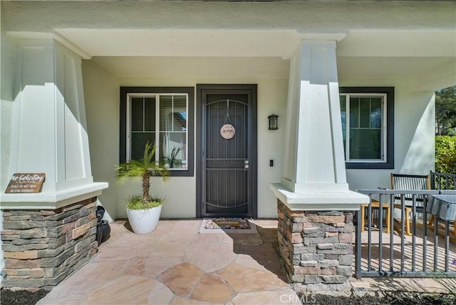 31164 Twilight Vista Dr, Menifee, CA 92584 - doorway to property featuring covered porch and stucco siding
