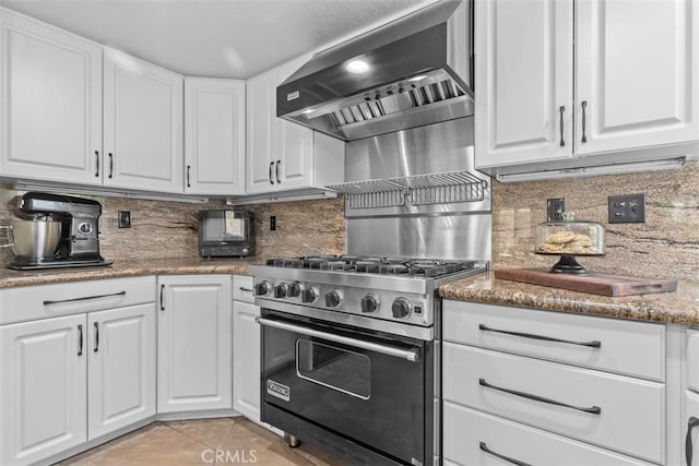 1200 Cerca, San Clemente, CA 92673 - kitchen with wall chimney range hood, premium range, light tile patterned floors, and white cabinets