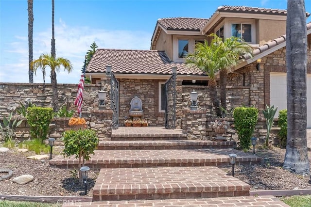 1200 Cerca, San Clemente, CA 92673 - view of front facade with a tiled roof, stone siding, stucco siding, and a garage