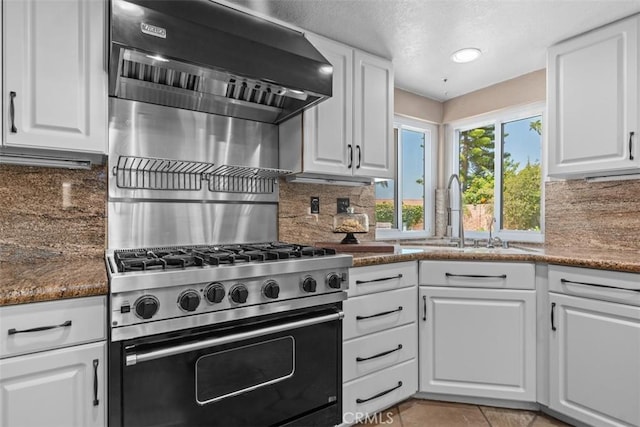 1200 Cerca, San Clemente, CA 92673 - kitchen with high end stove, backsplash, white cabinets, ventilation hood, and light tile patterned flooring