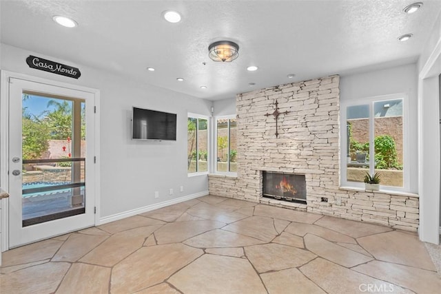1200 Cerca, San Clemente, CA 92673 - unfurnished living room featuring plenty of natural light, a fireplace, recessed lighting, and a textured ceiling