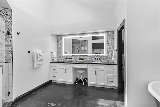 1200 Cerca, San Clemente, CA 92673 - bathroom featuring a stall shower, double vanity, vaulted ceiling, decorative backsplash, and a freestanding tub