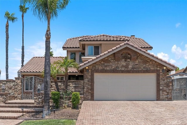 1200 Cerca, San Clemente, CA 92673 - view of front of house featuring a tiled roof, stone siding, decorative driveway, and an attached garage