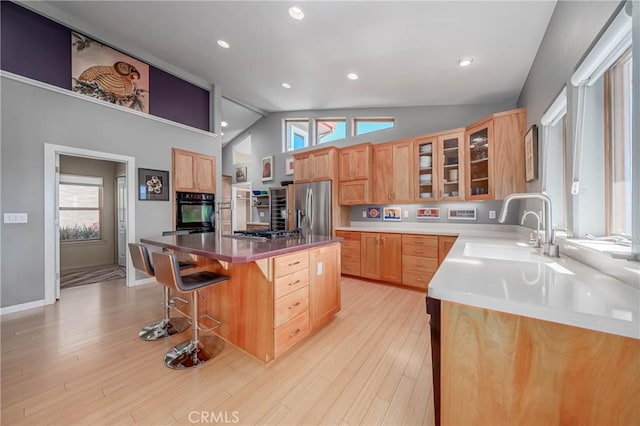 3165 Keeling Ave, Lakeport, CA 95453 - kitchen with lofted ceiling, glass insert cabinets, a kitchen island, a kitchen bar, and healthy amount of natural light
