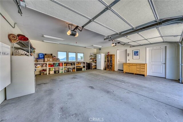 3165 Keeling Ave, Lakeport, CA 95453 - garage featuring freestanding refrigerator and a garage door opener