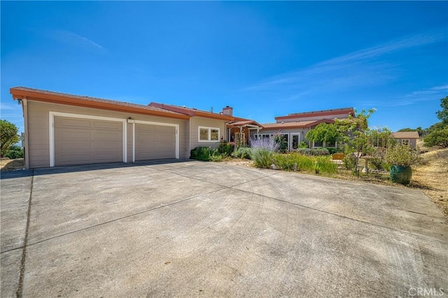 3165 Keeling Ave, Lakeport, CA 95453 - ranch-style house with concrete driveway, a garage, and a chimney