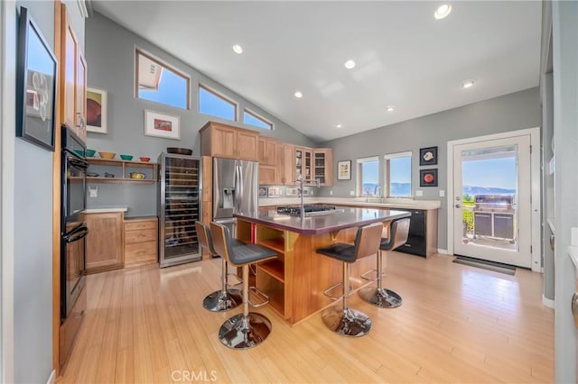 3165 Keeling Ave, Lakeport, CA 95453 - kitchen featuring light wood-type flooring, beverage cooler, a kitchen bar, lofted ceiling, and glass insert cabinets