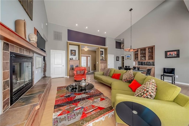 3165 Keeling Ave, Lakeport, CA 95453 - living room with high vaulted ceiling, wood finished floors, a tiled fireplace, and recessed lighting