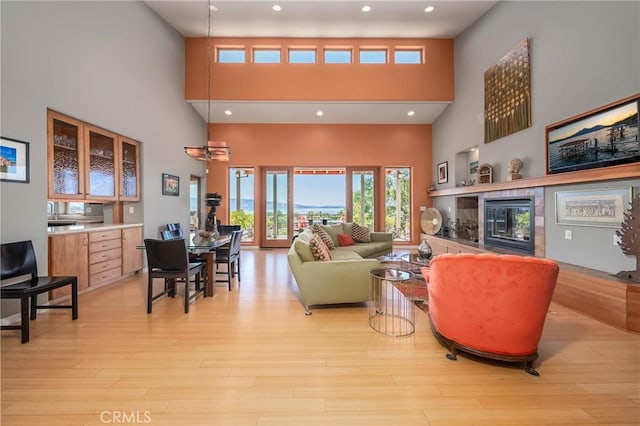 3165 Keeling Ave, Lakeport, CA 95453 - living room featuring a high ceiling, light wood-style floors, a tile fireplace, and recessed lighting