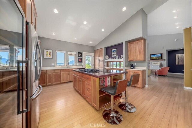 3165 Keeling Ave, Lakeport, CA 95453 - kitchen with stainless steel appliances, a kitchen island, open shelves, light wood finished floors, and high vaulted ceiling