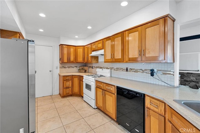 23859 S Rd, Apple Valley, CA 92307 - kitchen with black dishwasher, freestanding refrigerator, white gas range oven, tasteful backsplash, and light tile patterned flooring