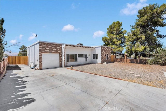 23859 S Rd, Apple Valley, CA 92307 - view of front of property with a garage, driveway, and stone siding