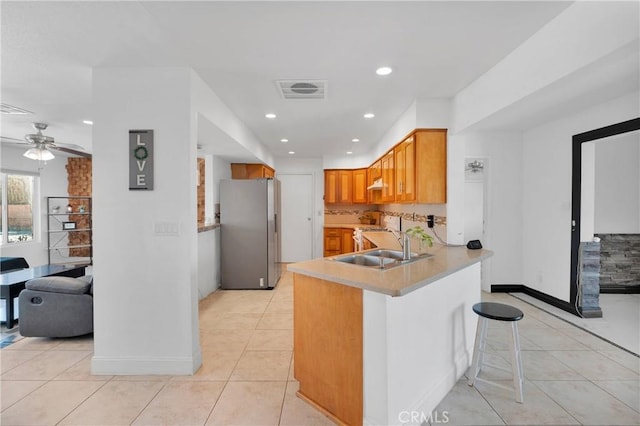 23859 S Rd, Apple Valley, CA 92307 - kitchen featuring freestanding refrigerator, light tile patterned floors, a peninsula, light countertops, and recessed lighting